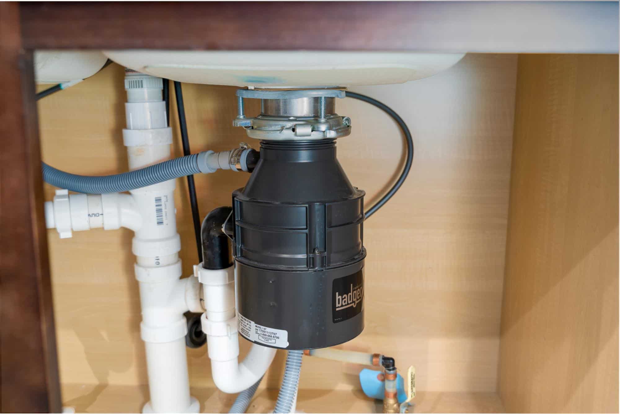 Closeup of a garbage disposal under a sink